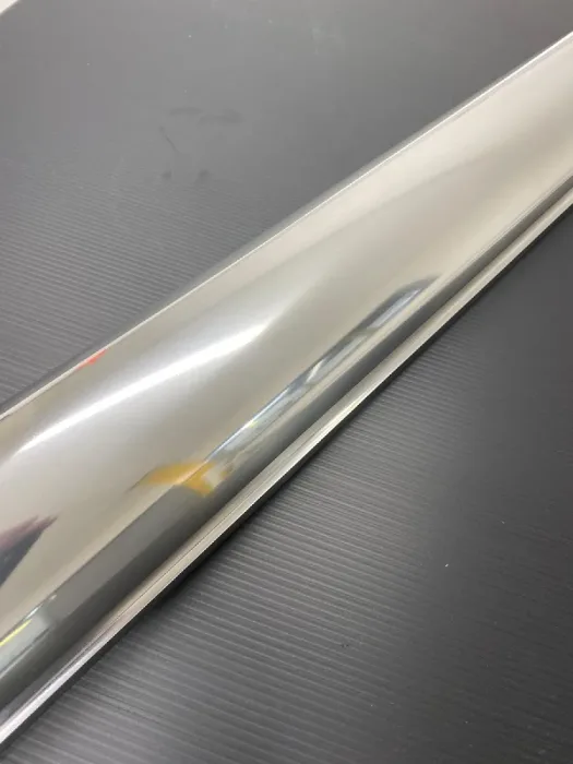 Polished trim detail running along the edge of a carbon fibre panel