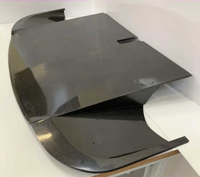 Large carbon fibre clamshell on the bench, finished in gloss twill