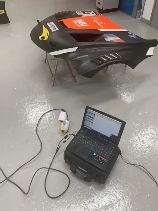 3D scanning a liveried race clamshell, scanner and laptop capturing the surface